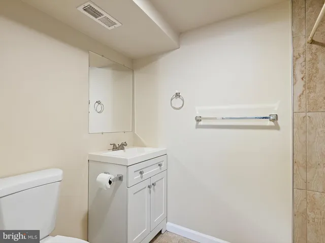 a bathroom with a sink toilet and a mirror
