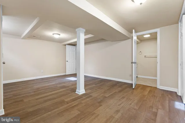 an empty room with wooden floor