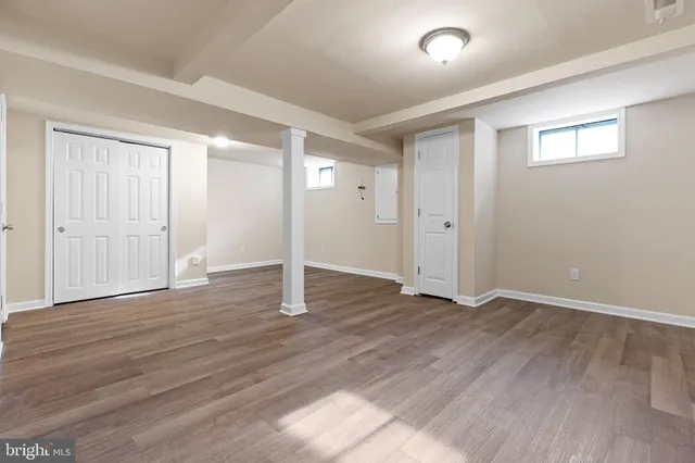 a view of an empty room with wooden floor