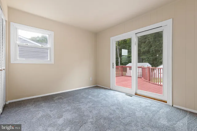 an empty room with sliding glass door