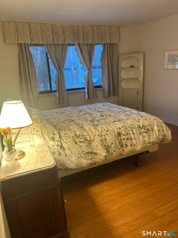 a bedroom with a bed and a night stand