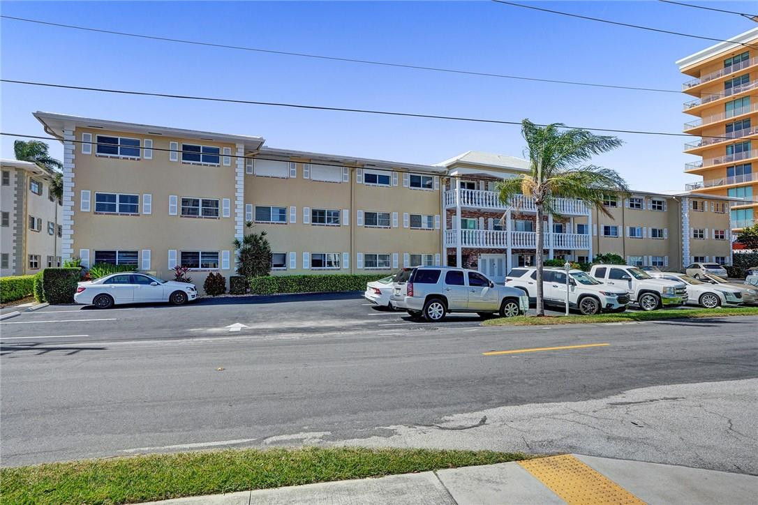 801 North Riverside Drive, Unit 7B Pompano Beach, FL 33062 - Photo 25 of 26 a car parked in front of a building