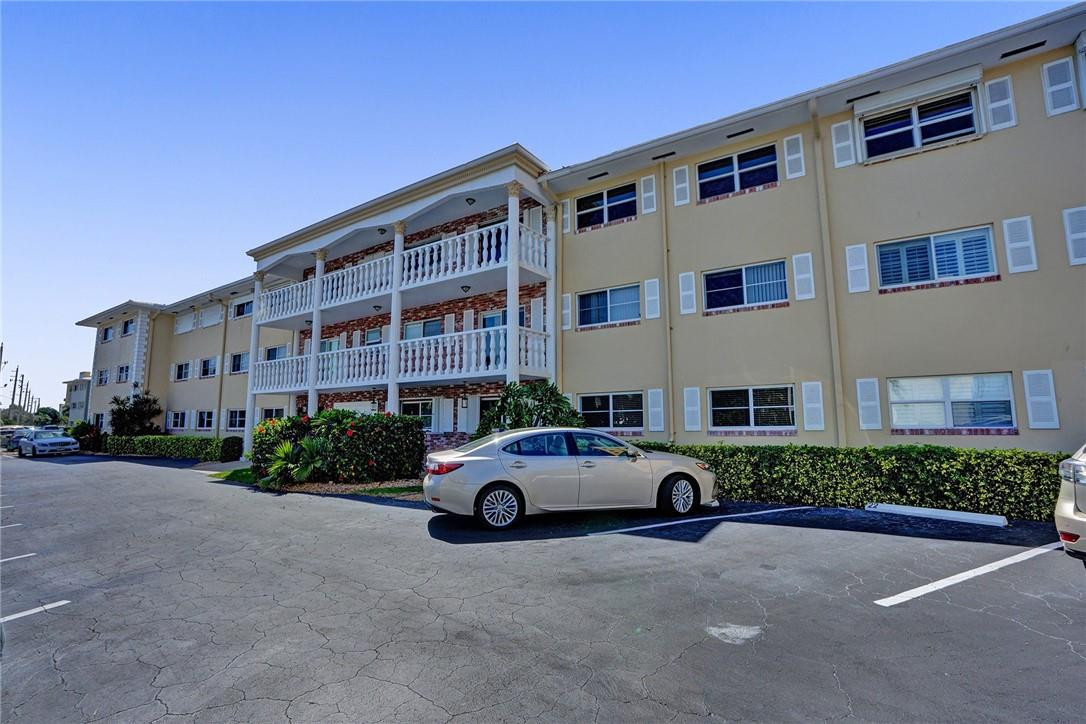 801 North Riverside Drive, Unit 7B Pompano Beach, FL 33062 - Photo 26 of 26 a front view of a house with parking