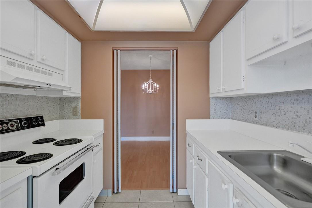 801 North Riverside Drive, Unit 7B Pompano Beach, FL 33062 - Photo 6 of 26 a kitchen with a sink stove and refrigerator