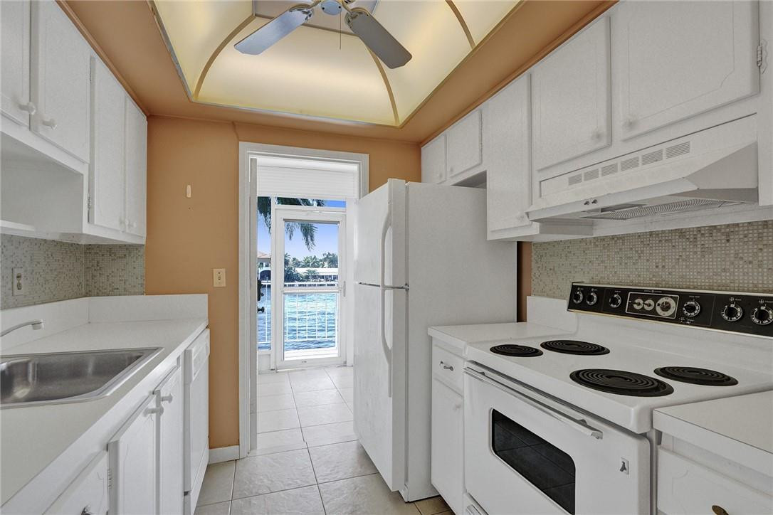 801 North Riverside Drive, Unit 7B Pompano Beach, FL 33062 - Photo 7 of 26 a kitchen with a stove a refrigerator and a sink