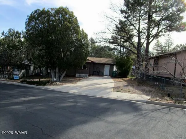 a view of a house with a yard and garage
