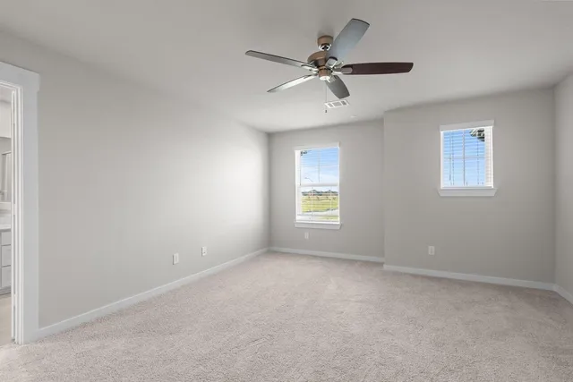 a view of a livingroom with a ceiling fan and window