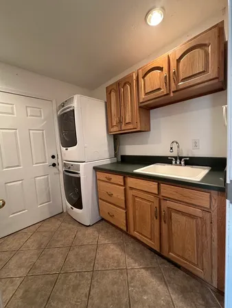 a kitchen with stainless steel appliances granite countertop a sink and a stove