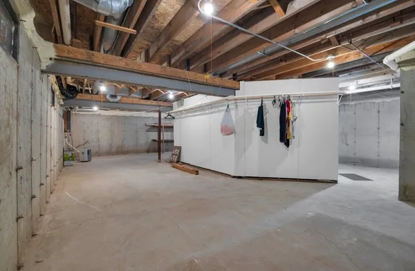 a view of water heater room with refrigerator
