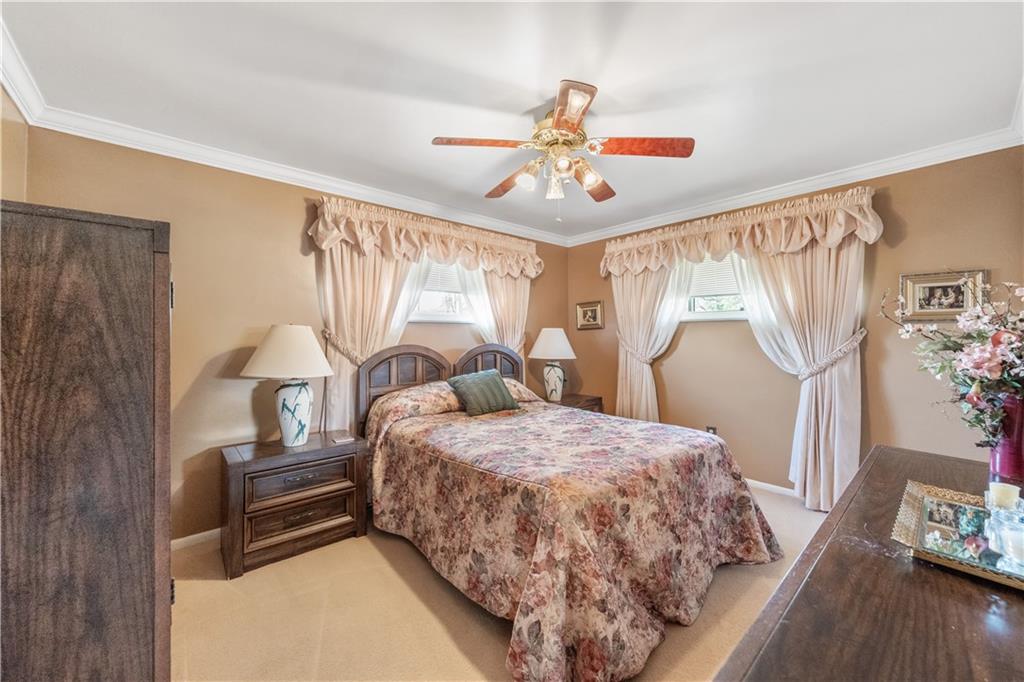 25 Willow Drive Monessen, PA 15062 - Photo 13 of 33 a bedroom with a bed and a chandelier