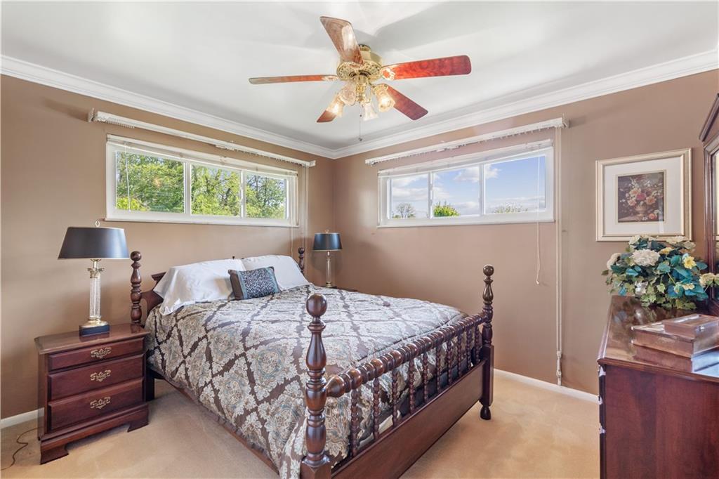 25 Willow Drive Monessen, PA 15062 - Photo 15 of 33 a bedroom with a bed and a chandelier