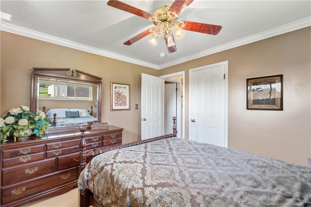 25 Willow Drive Monessen, PA 15062 - Photo 16 of 33 a bedroom with a bed and a chandelier