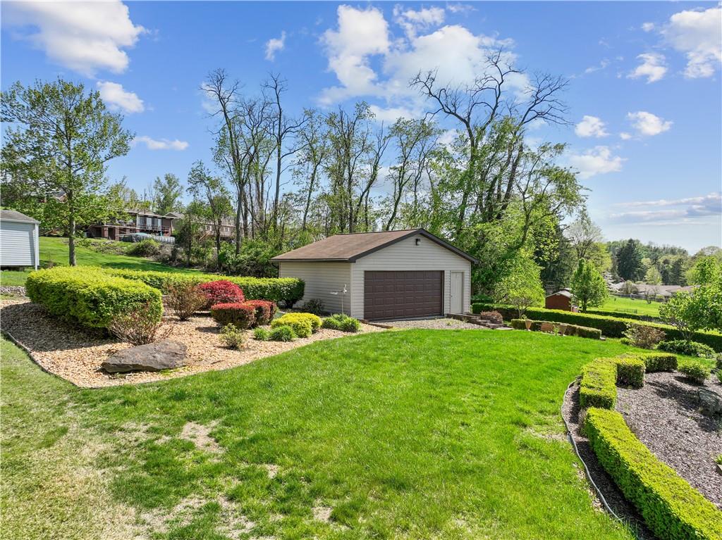 25 Willow Drive Monessen, PA 15062 - Photo 25 of 33 a front view of a house with garden and trees