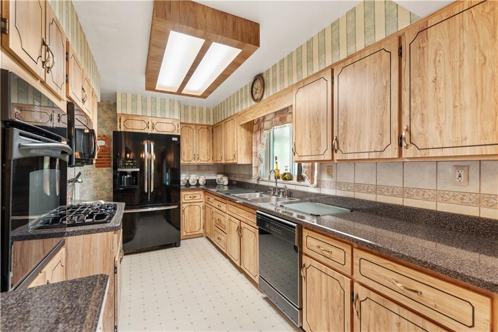 25 Willow Drive Monessen, PA 15062 - Photo 7 of 33 a kitchen with stainless steel appliances kitchen island granite countertop a refrigerator and a sink
