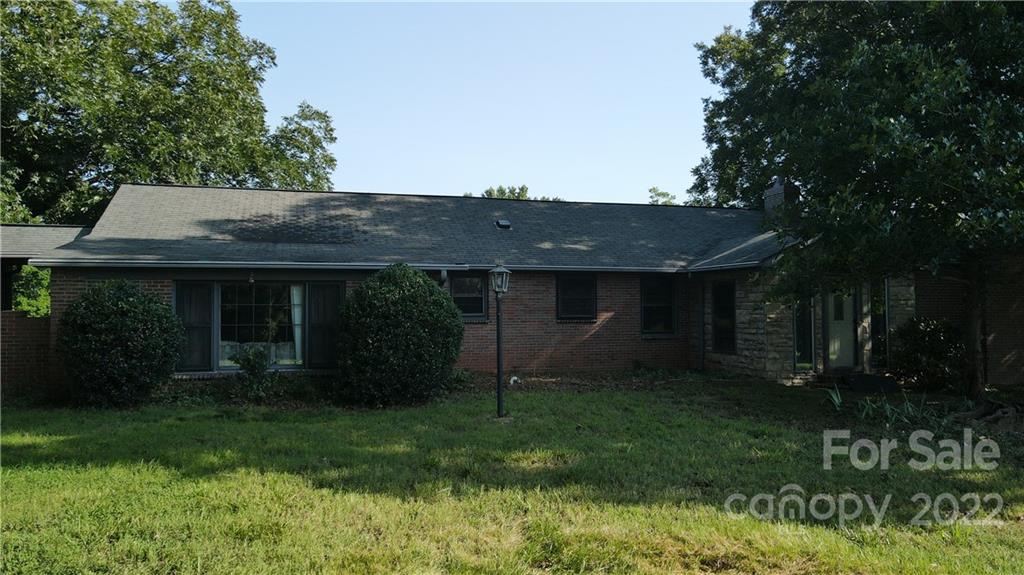 9030 Potter Road Lancaster, SC 29720 - Photo 12 of 26 a view of a house with a yard plants and large tree