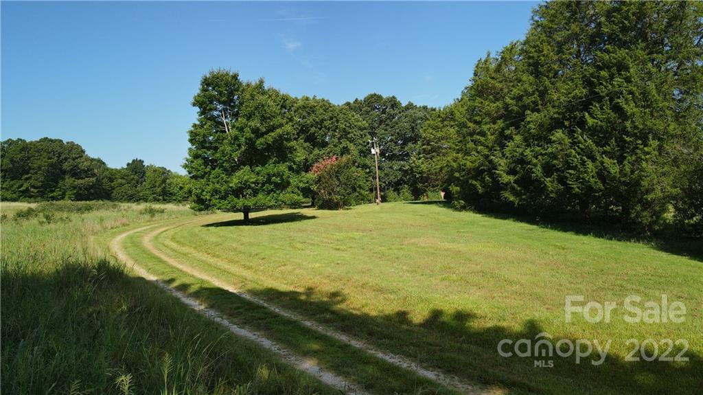 9030 Potter Road Lancaster, SC 29720 - Photo 21 of 26 a view of a swimming pool with a yard