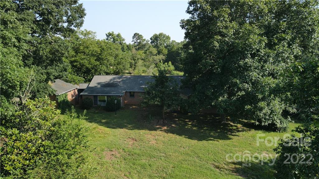 9030 Potter Road Lancaster, SC 29720 - Photo 8 of 26 a view of a lake with a house in the background