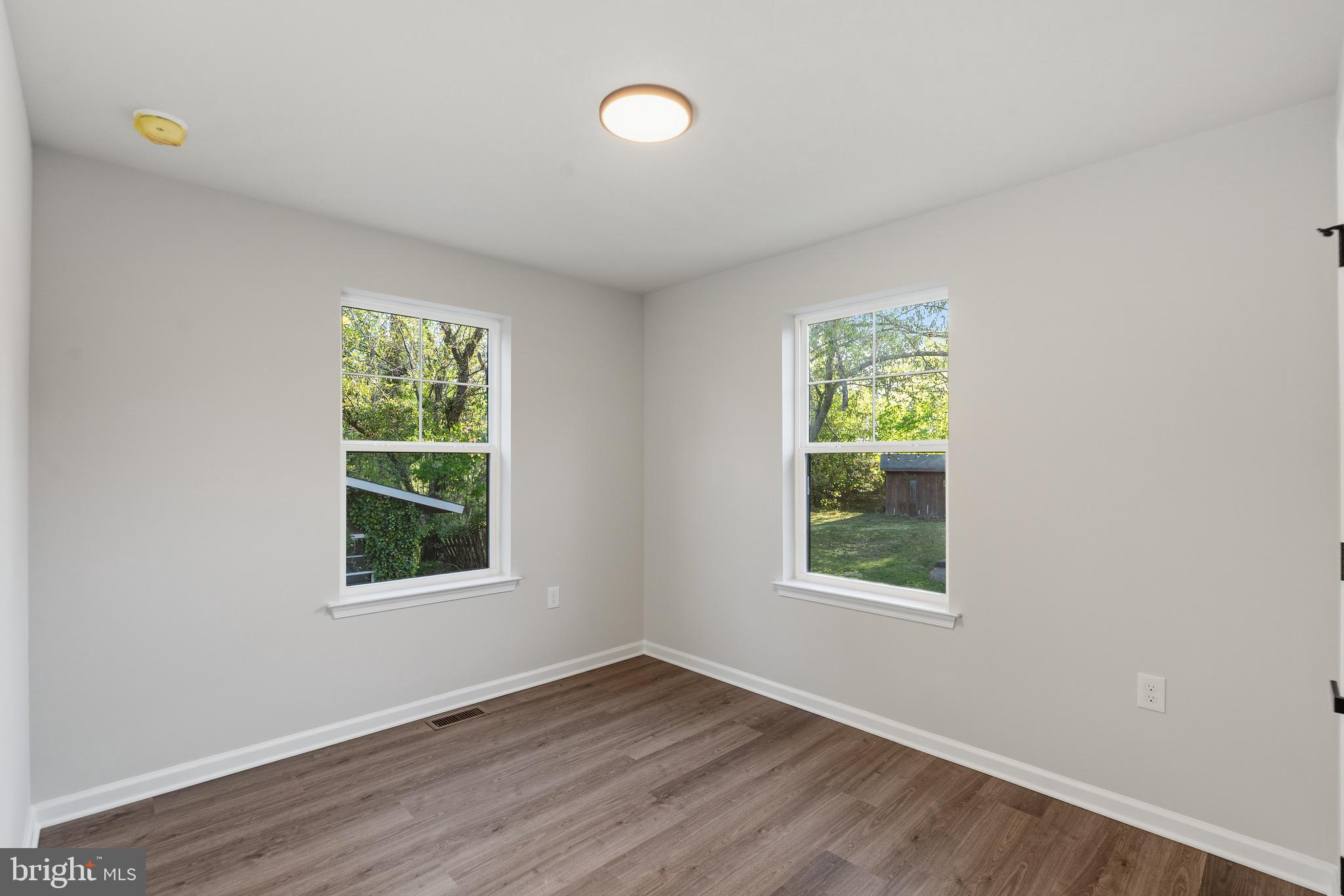 212 Lotus Avenue Voorhees, NJ 08043 - Photo 16 of 39 an empty room with wooden floor and windows