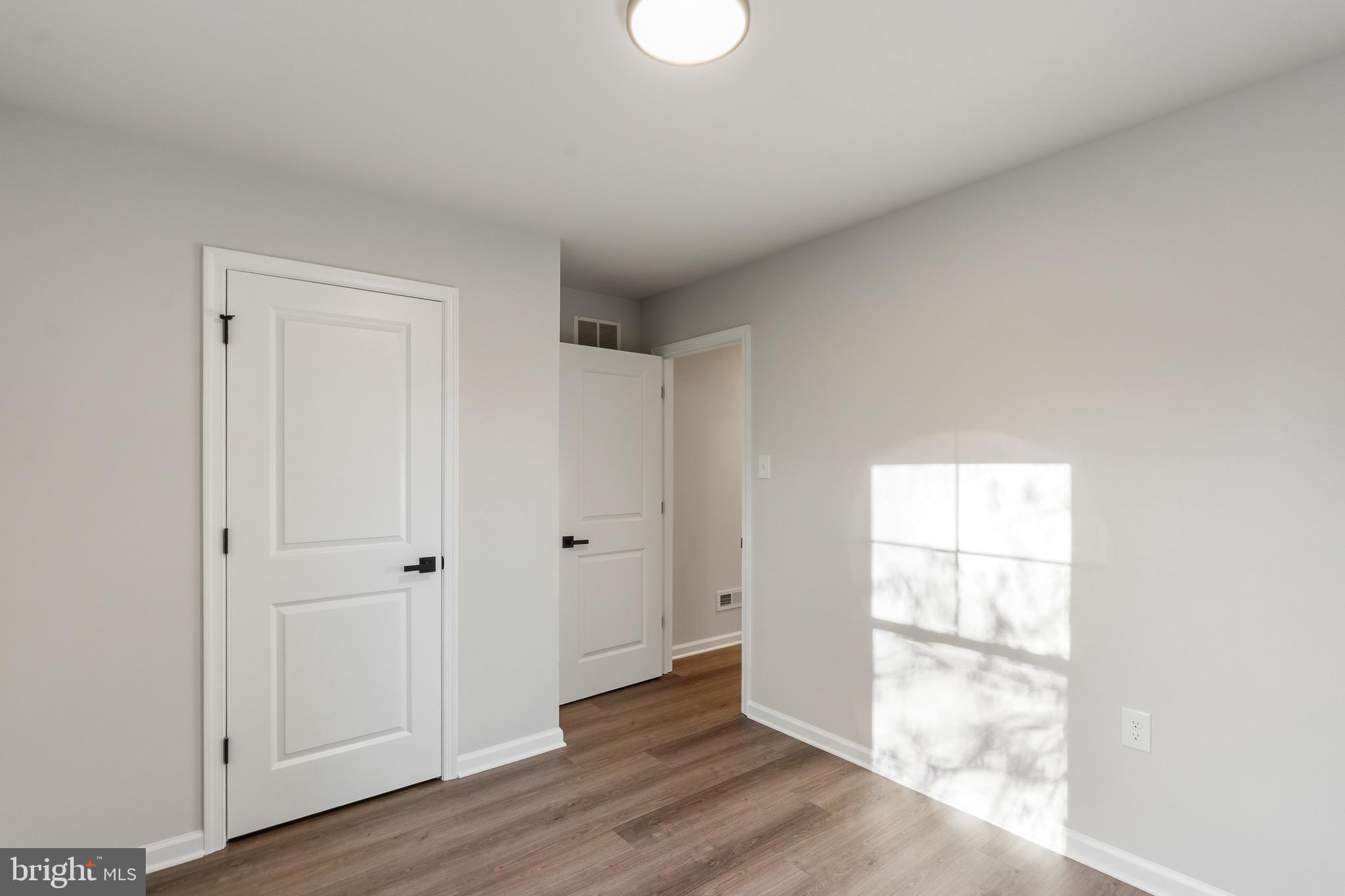 212 Lotus Avenue Voorhees, NJ 08043 - Photo 17 of 39 a view of an empty room with wooden floor and a window