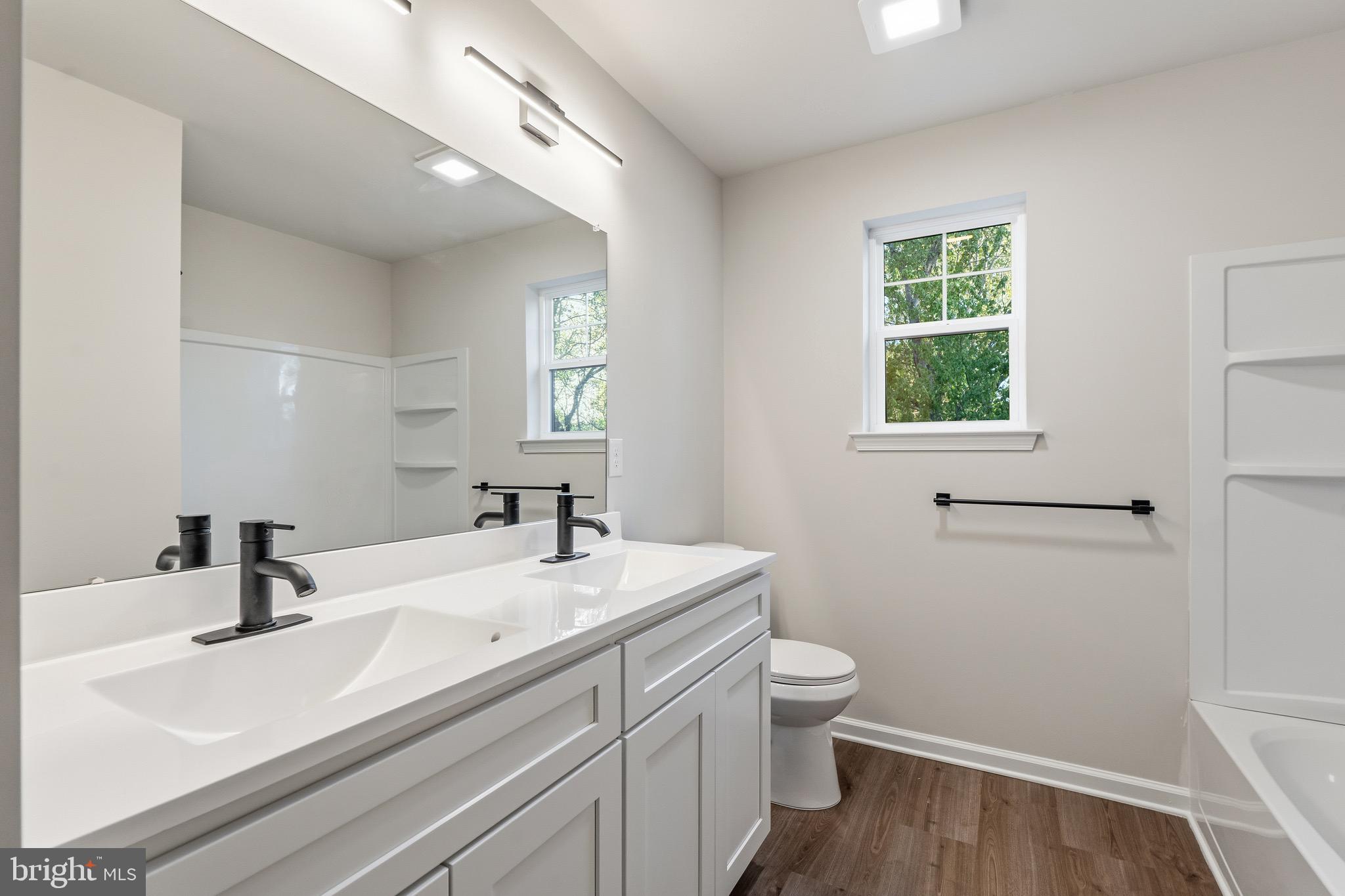 212 Lotus Avenue Voorhees, NJ 08043 - Photo 20 of 39 a bathroom with a sink a toilet and a window