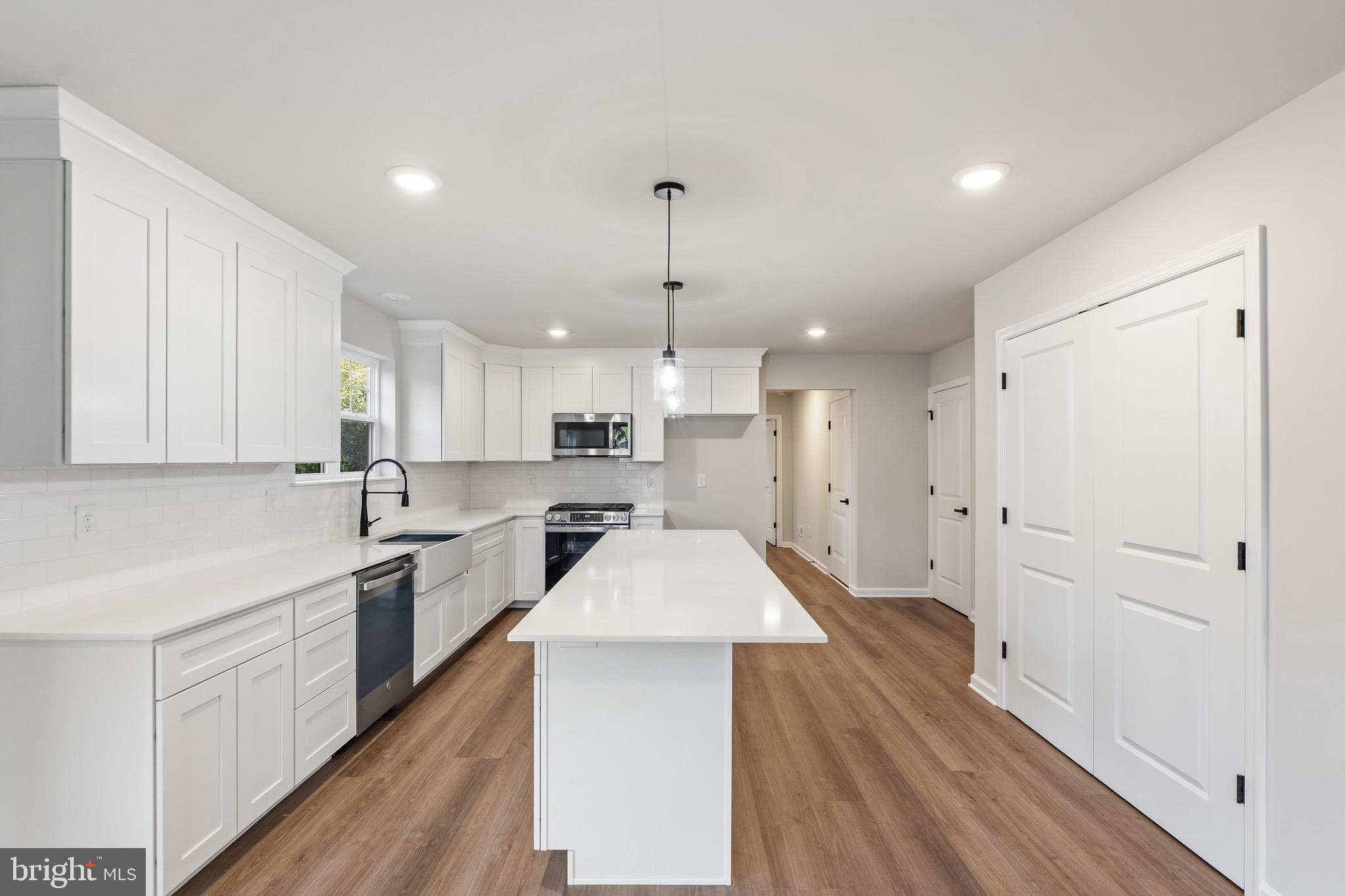 212 Lotus Avenue Voorhees, NJ 08043 - Photo 7 of 39 a large kitchen with cabinets a sink dishwasher a stove and a refrigerator with wooden floor