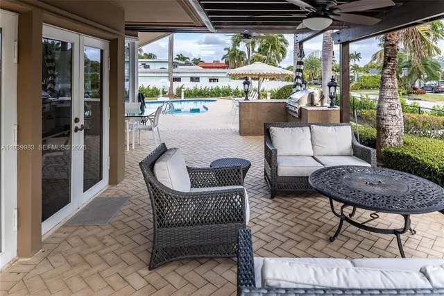 a view of a house with swimming pool and sitting area