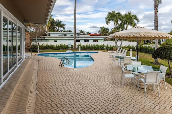 a view of swimming pool with a patio