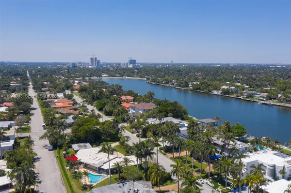 a front view of a house with swimming pool and porch with furniture