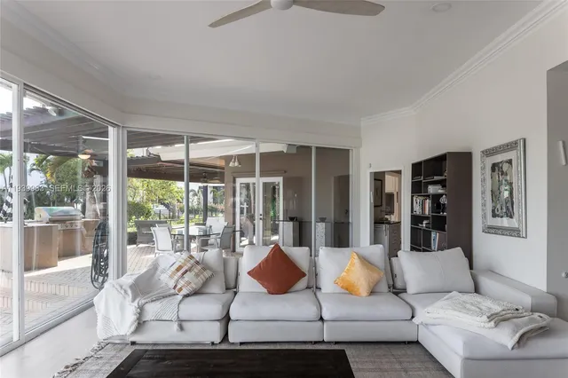 a living room with furniture and large window with outer view