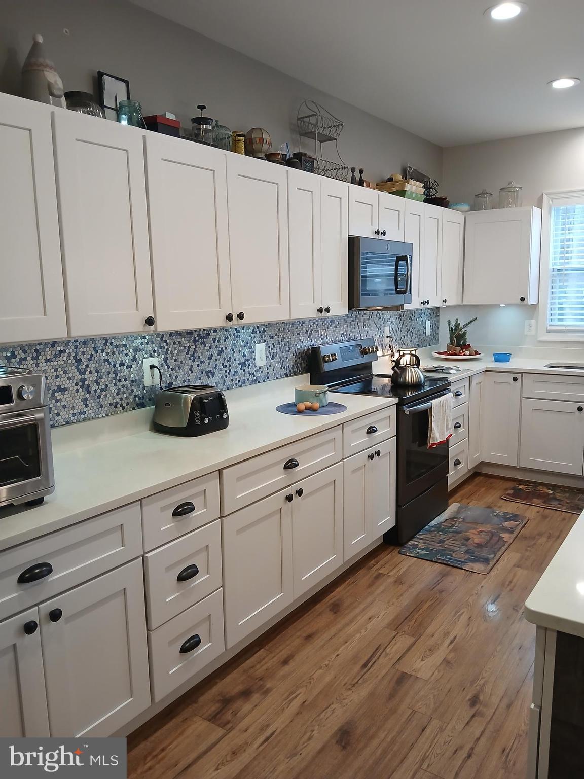 11337 Russell Road Purcellville, VA 20132 - Photo 11 of 18 a kitchen with cabinets appliances a sink and a counter top space