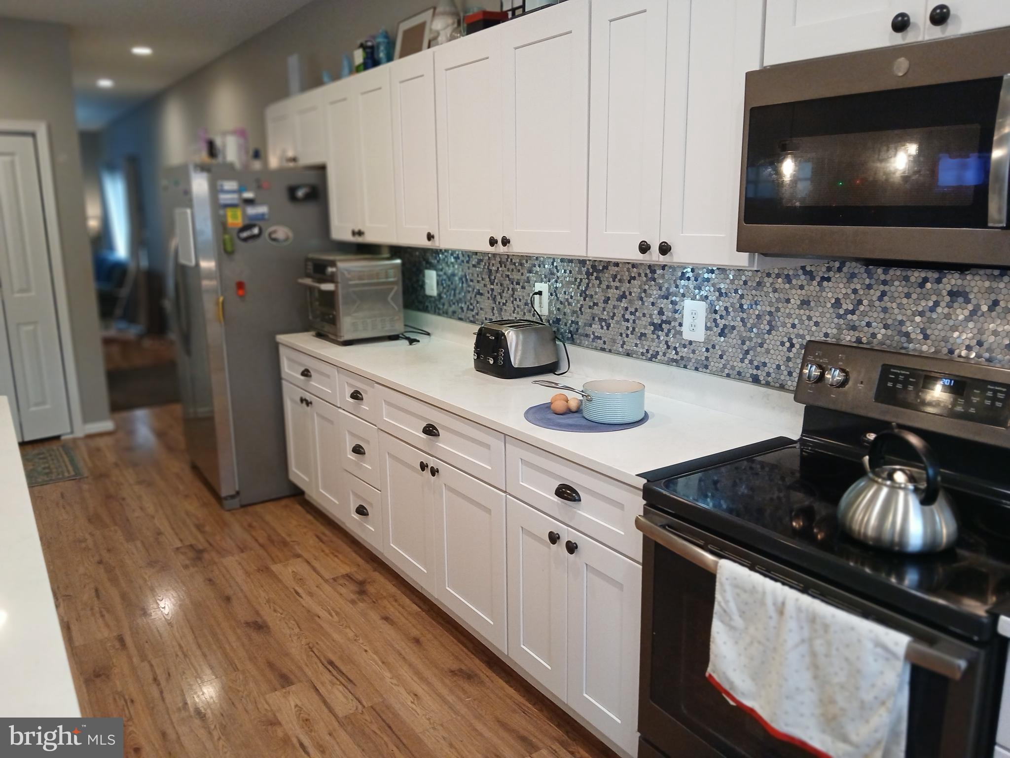 11337 Russell Road Purcellville, VA 20132 - Photo 12 of 18 a kitchen with stainless steel appliances a sink stove and cabinets