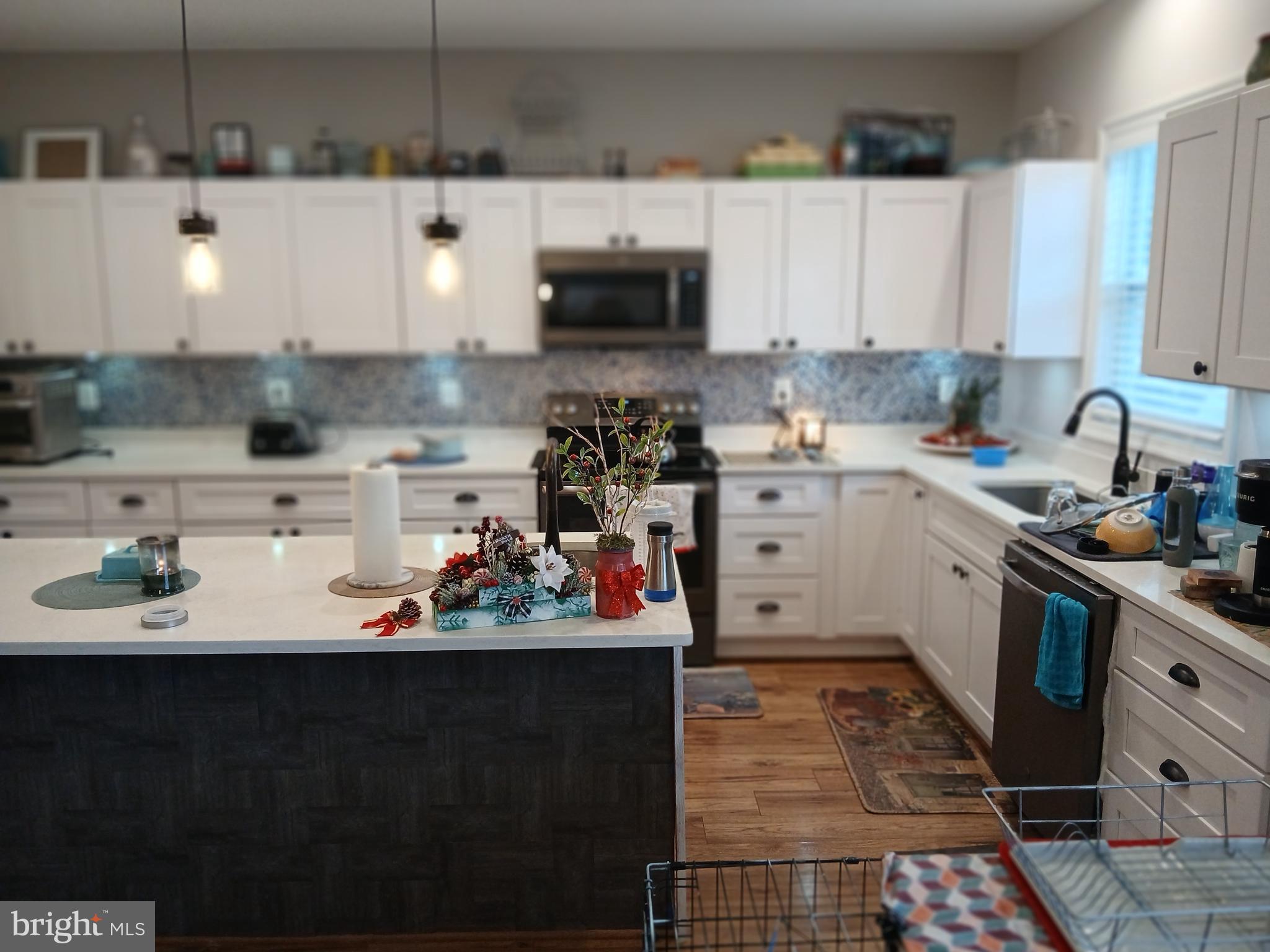 11337 Russell Road Purcellville, VA 20132 - Photo 6 of 18 a kitchen with a sink a stove and cabinets