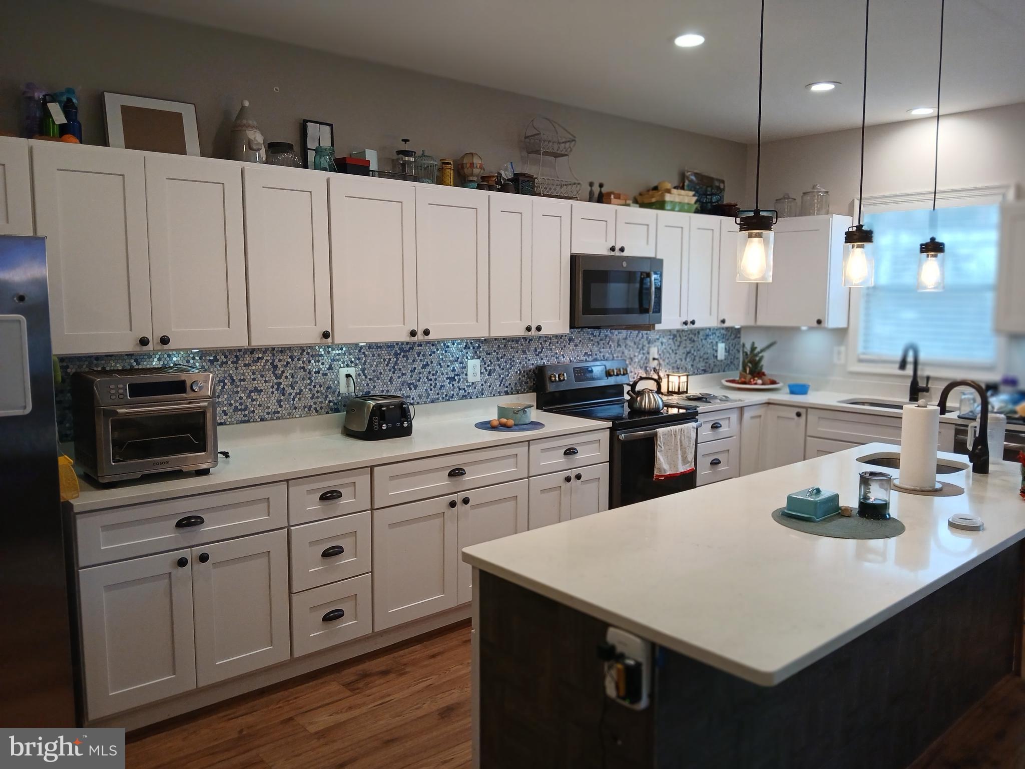11337 Russell Road Purcellville, VA 20132 - Photo 10 of 18 a kitchen with cabinets appliances a sink and a counter top space