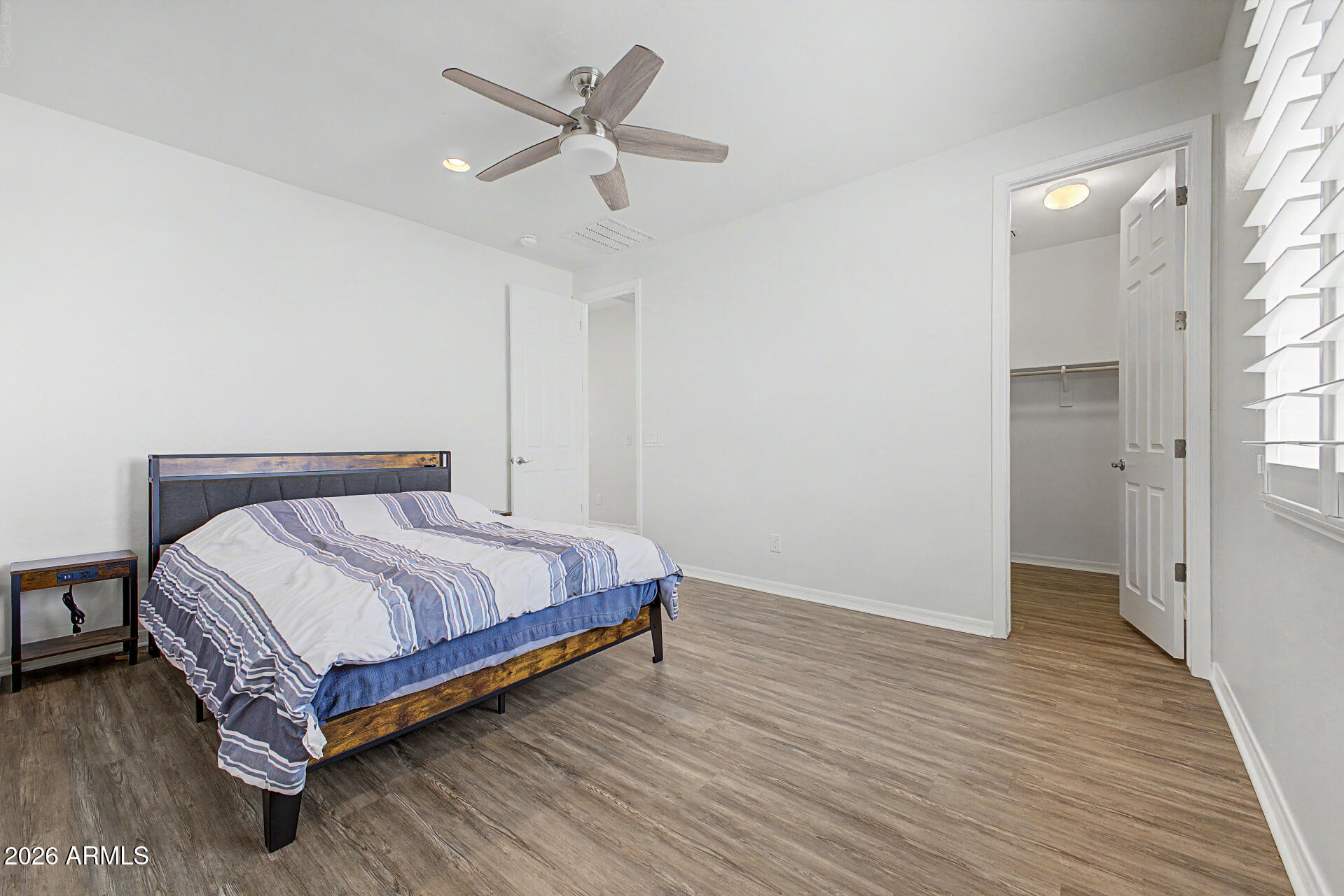 1076 East Kensington Road Gilbert, AZ 85297 - Photo 27 of 73 a spacious bedroom with a bed and a chandelier