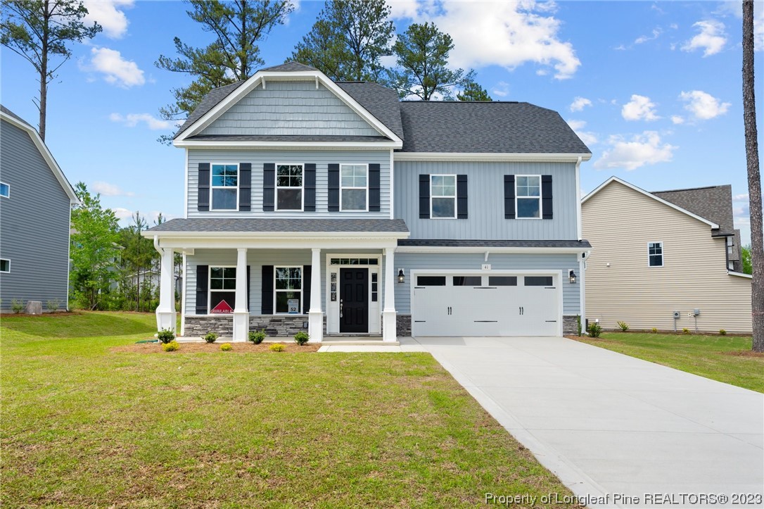 a view of a white house with swimming pool in front of it
