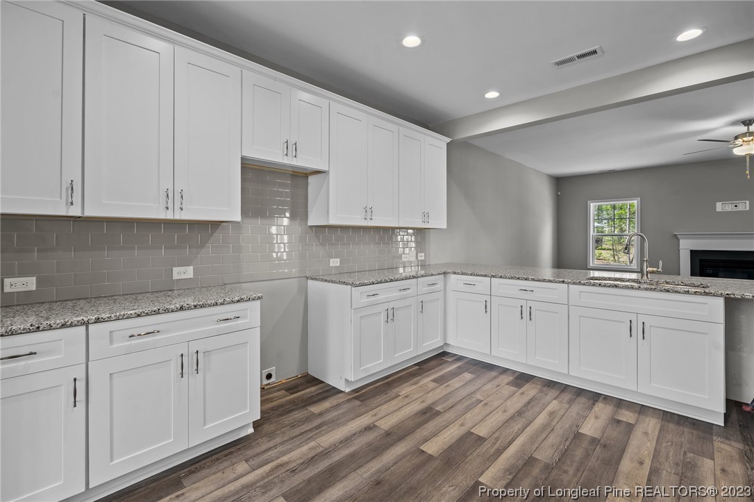 41 Timber Hill Crossing Spring Lake Spring Lake, NC 28390 - Photo 3 of 16 a kitchen with granite countertop white cabinets and white appliances