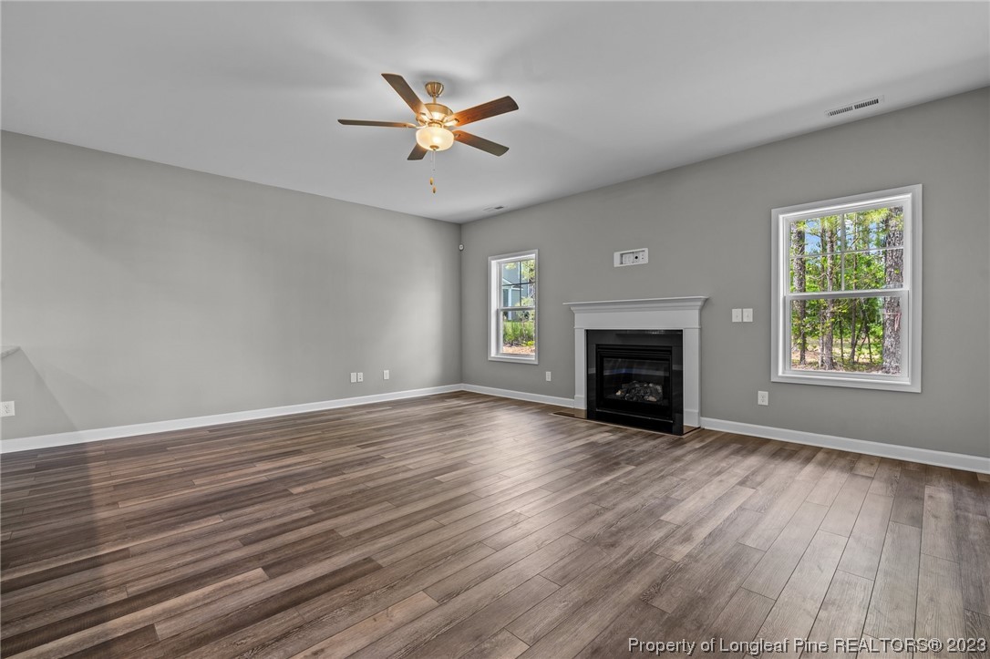 41 Timber Hill Crossing Spring Lake Spring Lake, NC 28390 - Photo 5 of 16 an empty room with wooden floor fireplace and windows