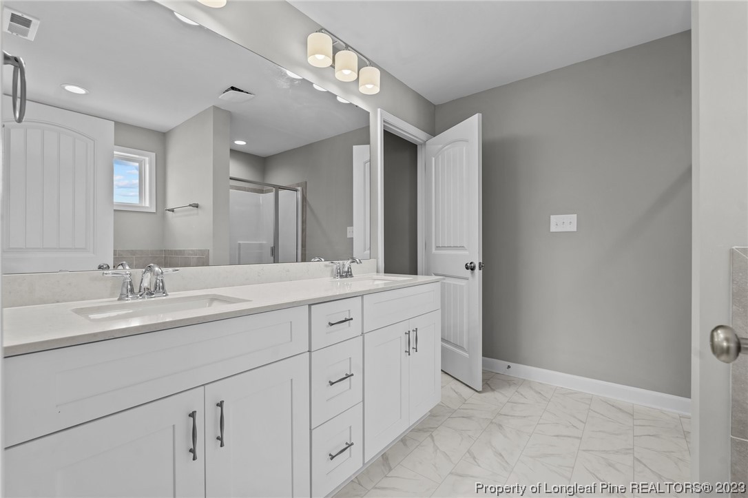 41 Timber Hill Crossing Spring Lake Spring Lake, NC 28390 - Photo 8 of 16 a bathroom with double sink and a mirror