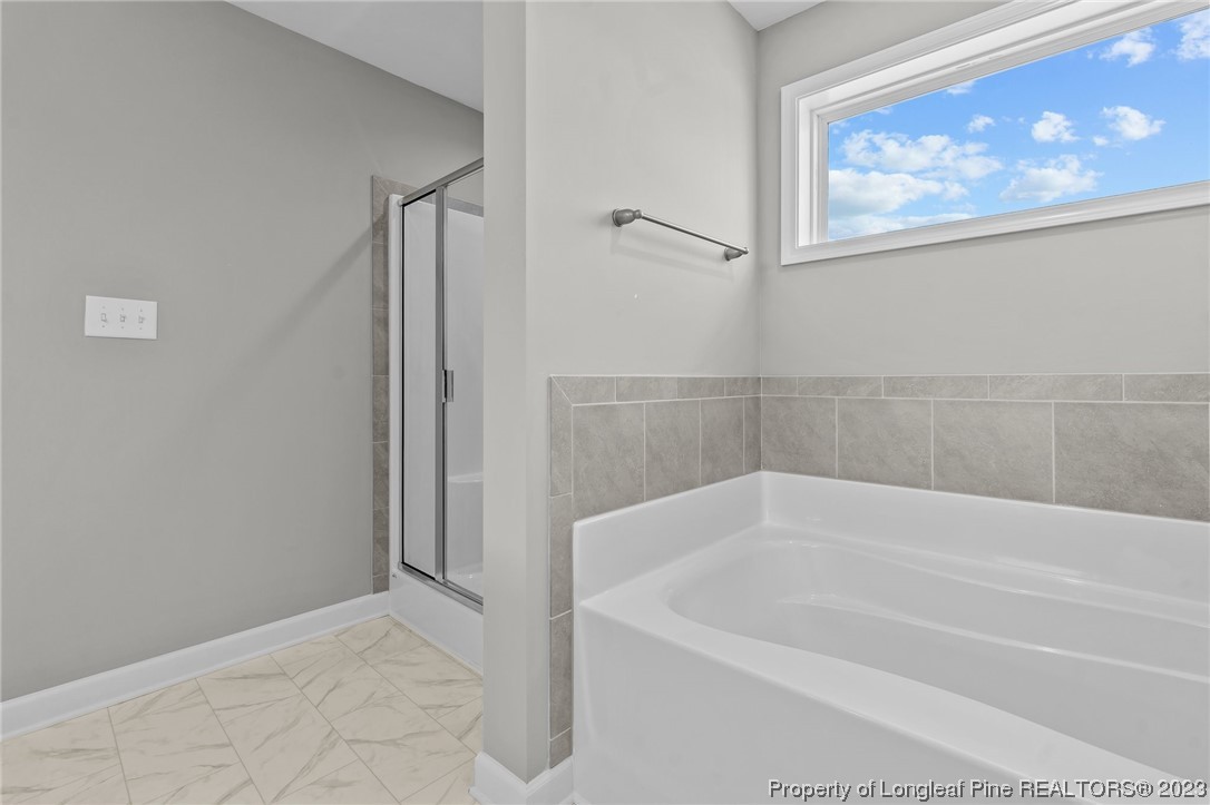 41 Timber Hill Crossing Spring Lake Spring Lake, NC 28390 - Photo 9 of 16 a white bath tub sitting next to a window