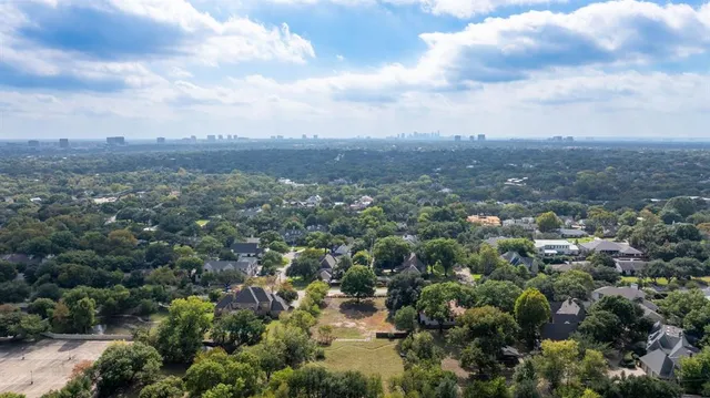 a view of a city with lush green forest