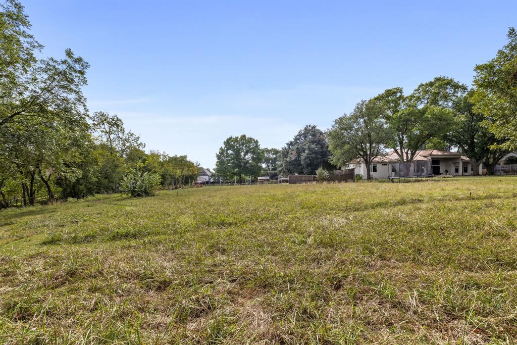 6639 Willow Lane Dallas, TX 75230 - Photo 7 of 14 a view of outdoor space with green field and trees all around