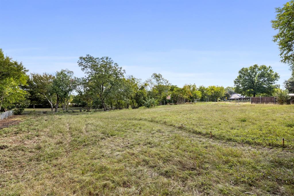 6639 Willow Lane Dallas, TX 75230 - Photo 8 of 14 a view of a field with trees in the background