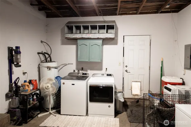 a utility room with multiple dryer and washer