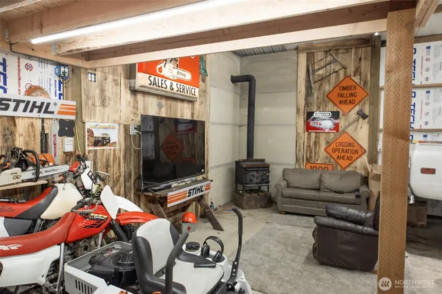 a living room with furniture a flat screen tv and a wall painting