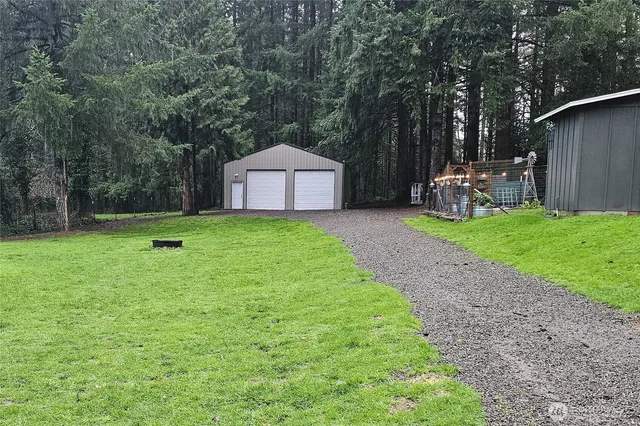 a backyard of a house with table and chairs