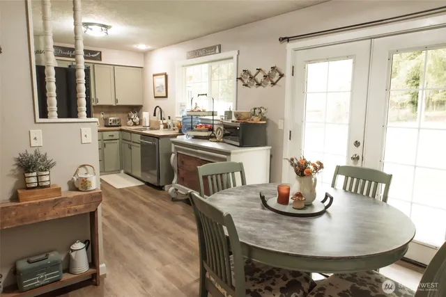 a kitchen with a table chairs stove and microwave