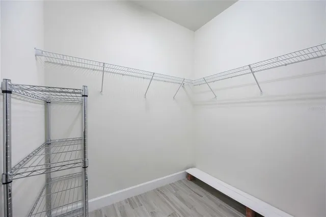 a front view of a house with a yard and potted plants
