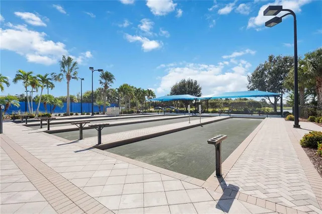a living room with patio furniture and a flat screen tv