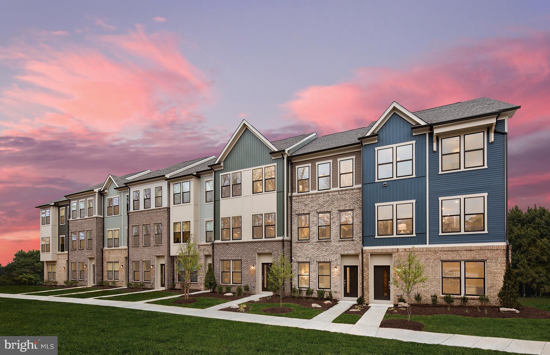 a front view of a residential apartment building with a yard