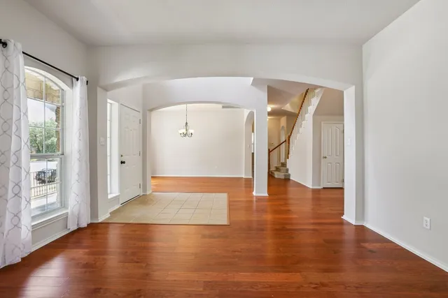wooden floor in an empty room with a window